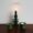 Dark green ceramic Christmas tree candle holder on dining table