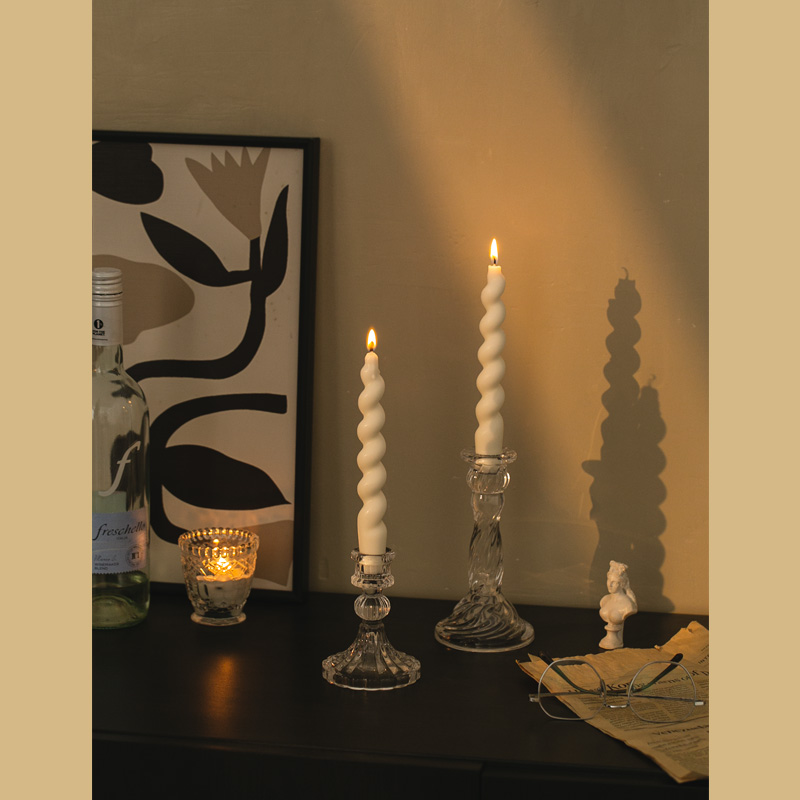 Elegant candlelight setup with vintage glass candle holders at dinner table