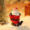 Laughing Santa resin ornament sitting with arms raised, festive red outfit – mini Christmas desktop figurine.