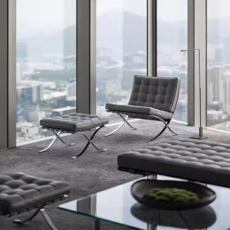 Italian leather Barcelona Chair with ottoman in executive office – luxury modern seating with stainless steel frame