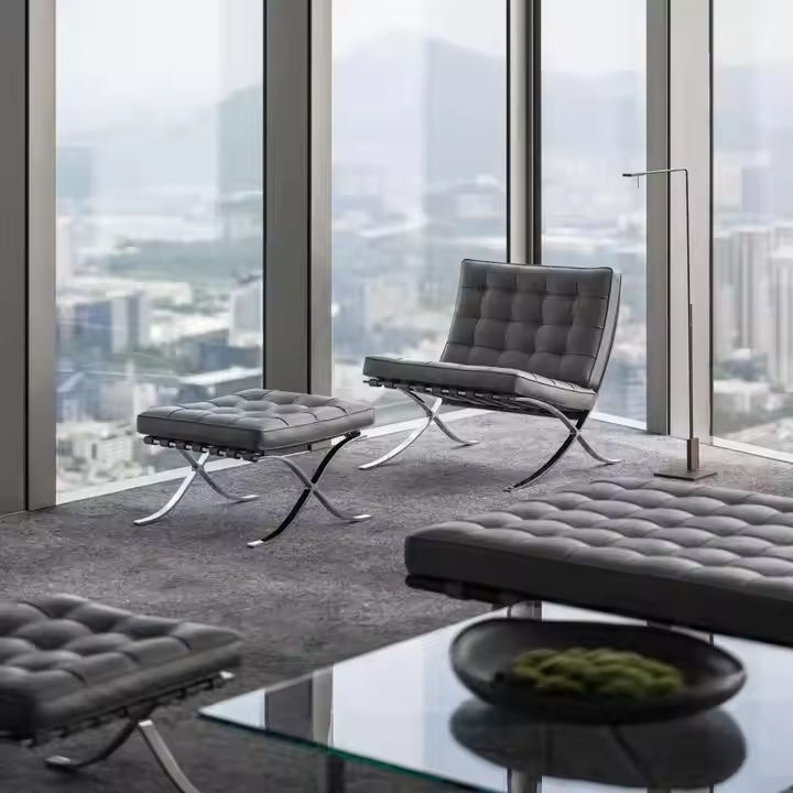 Italian leather Barcelona Chair with ottoman in executive office – luxury modern seating with stainless steel frame
