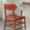 Back view detail of the red plastic chair showing ergonomic backrest design
