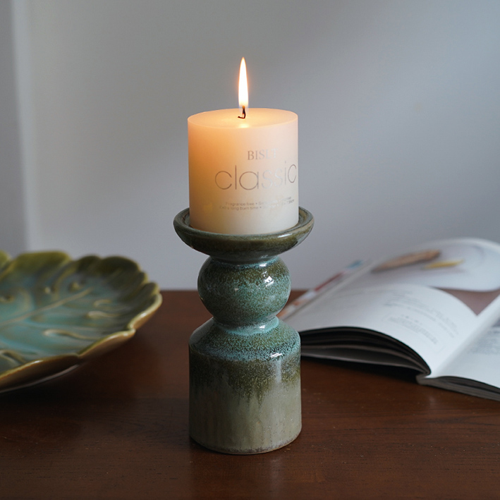 Classic Ceramic candle holder with candle light on the wood table display