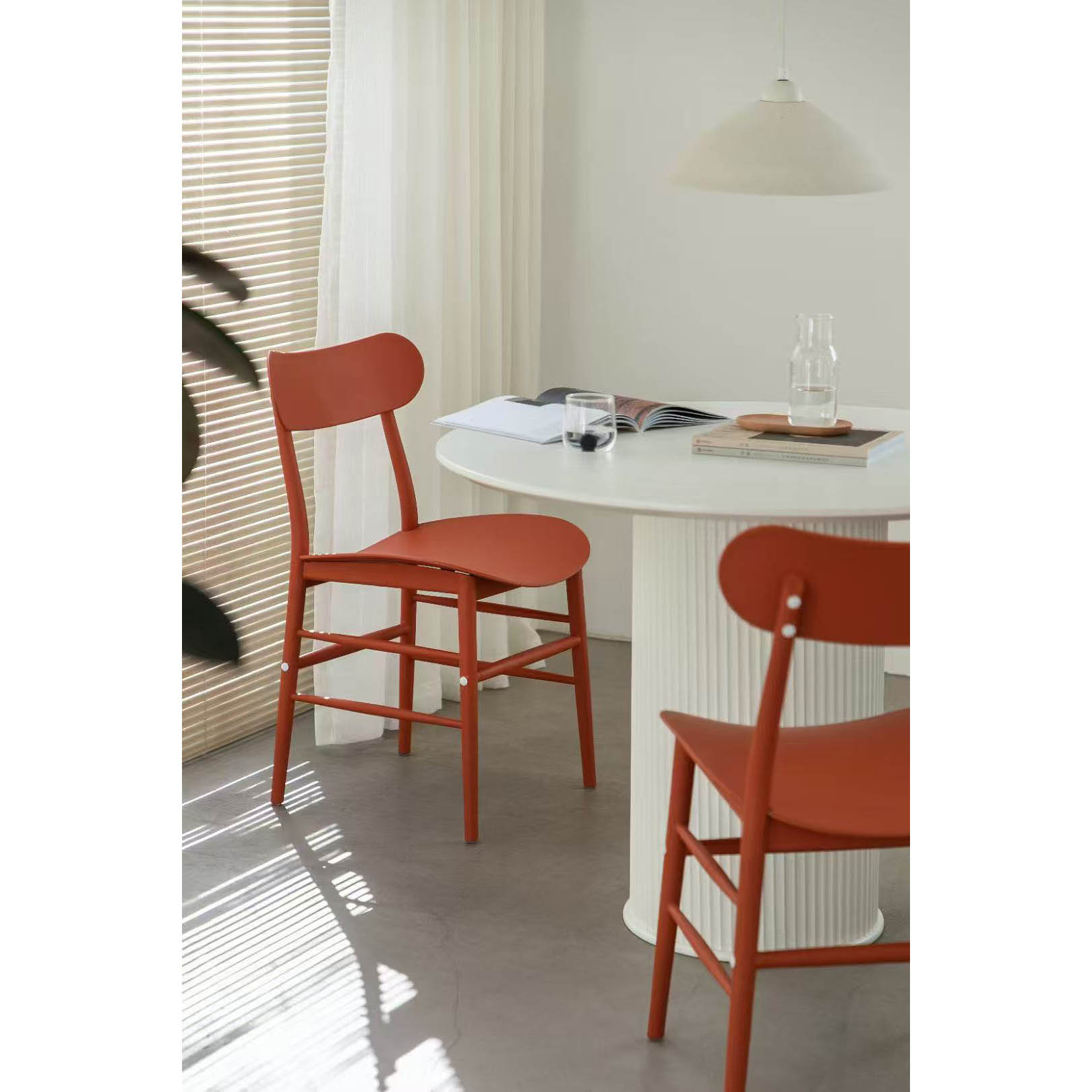 Close-up display of the red outdoor plastic dining chair